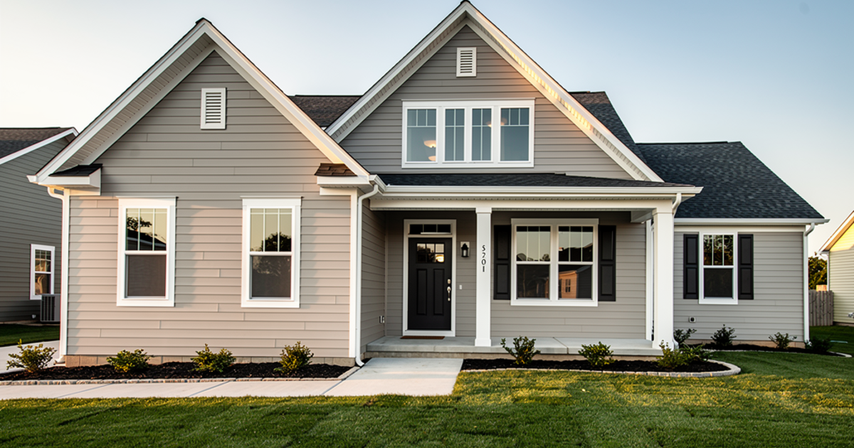 Contractor Installing New Vinyl Siding